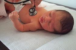 Doctor checking vital signs of baby